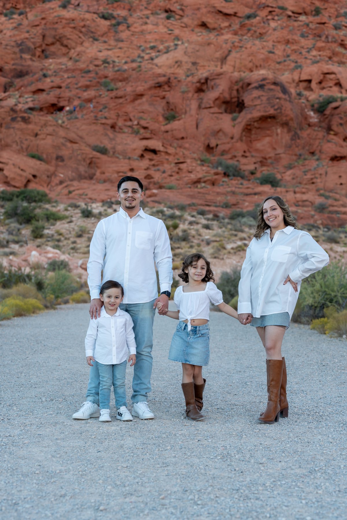 Family portrait with red-rock hills in the background