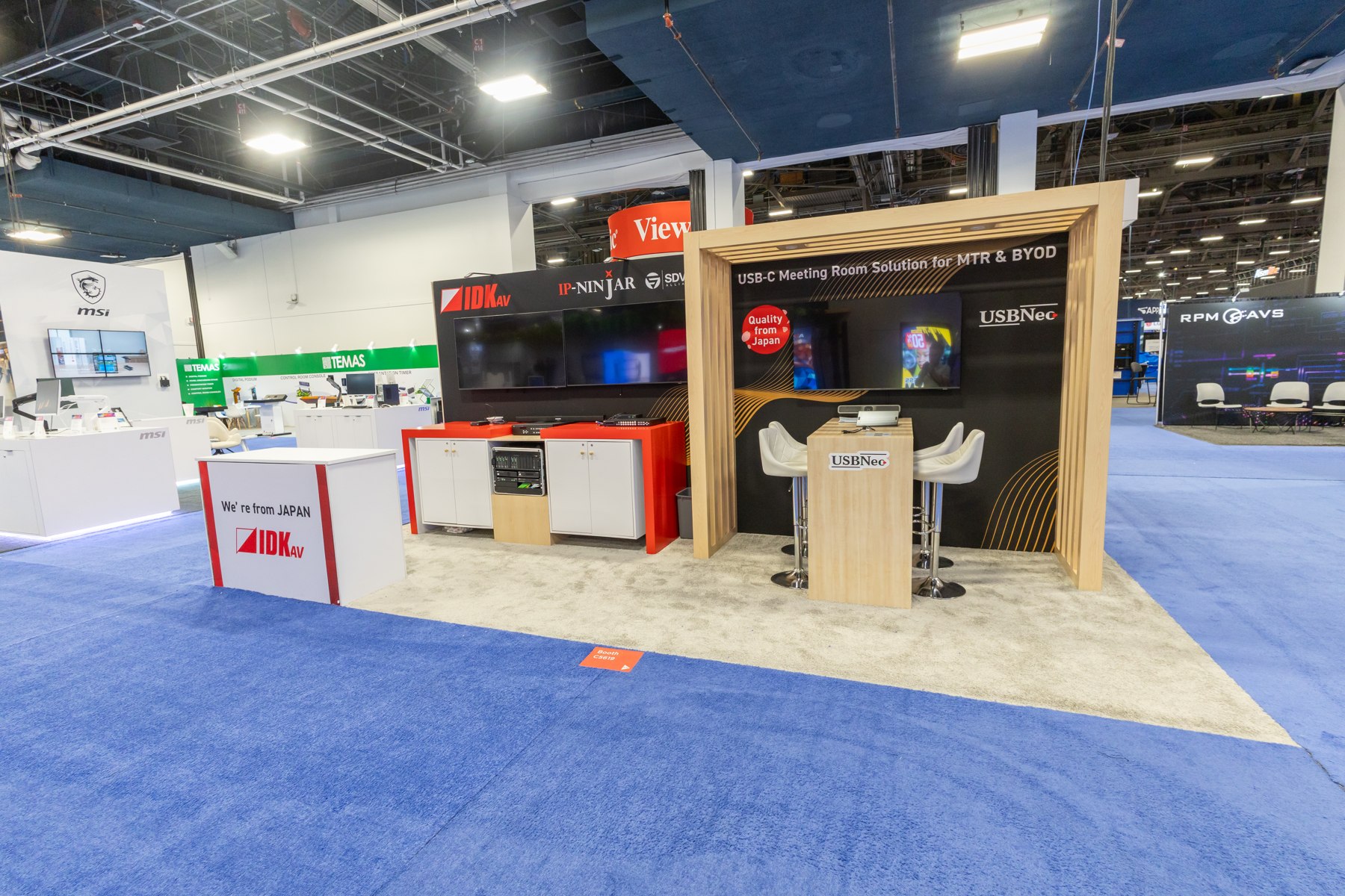 Open exhibit with branded counters and a wood-framed display